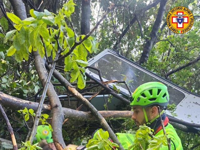 <p>Rescuers find the destroyed cable car which fell in woodland</p>
