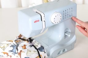 Child using Elna 525 Mini Sewing Machine in grey – first sewing machine for kids NZ