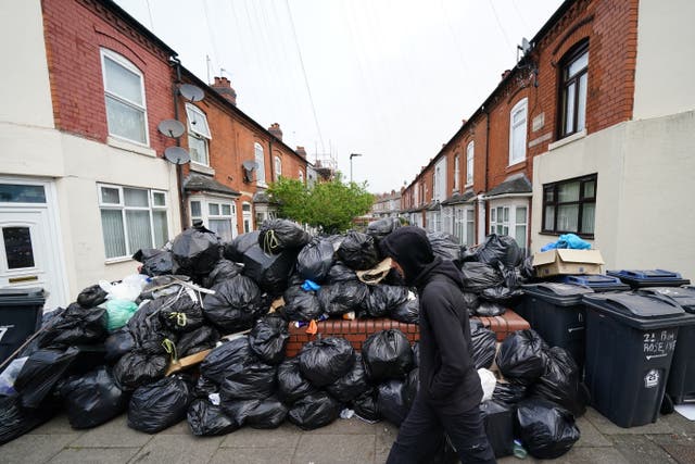 <p>A huge pile of black bin bags in between two rows of houses in Poplar Road in Birmingham</p>