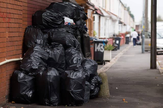 <p>Rubbish bags piled up in front of bins in Moseley Road, Birmingham</p>